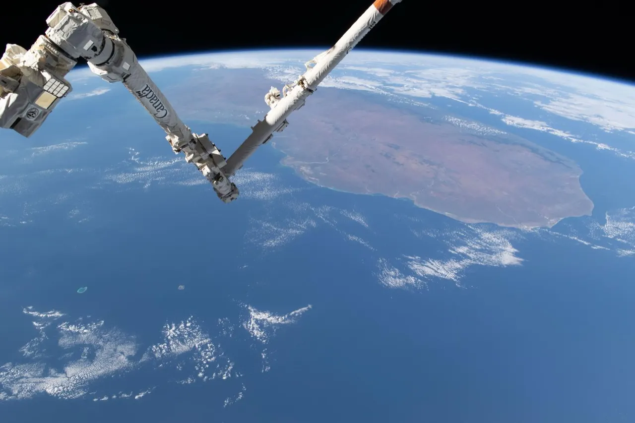 The Canadarm2 robotic arm on the International Space Station above Earth